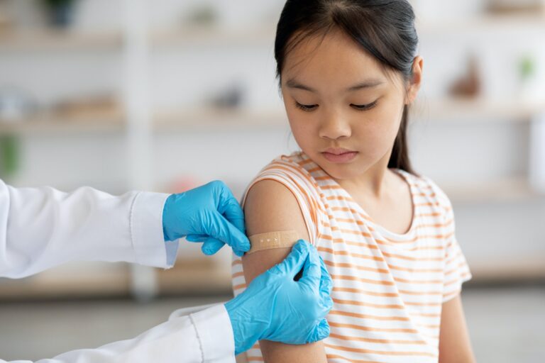 Cropped of nurse making vaccination for chinese kid